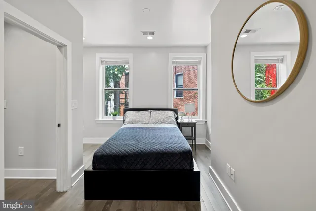 a bedroom with a bed and a mirror