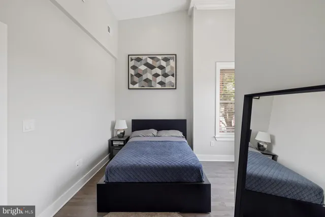 a view of empty room with a window and wooden floor