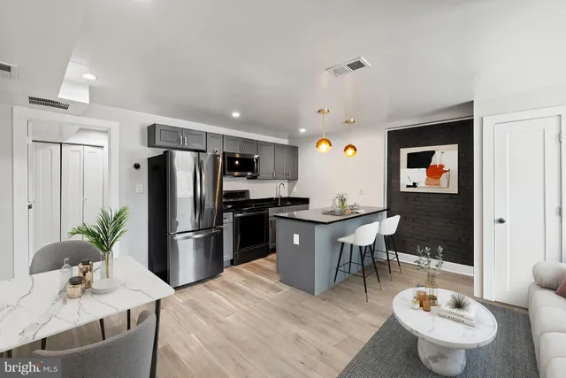 a kitchen with stainless steel appliances a refrigerator and a stove top oven