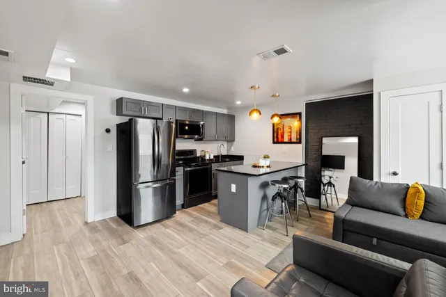 a kitchen with stainless steel appliances granite countertop a refrigerator a stove a sink and a refrigerator