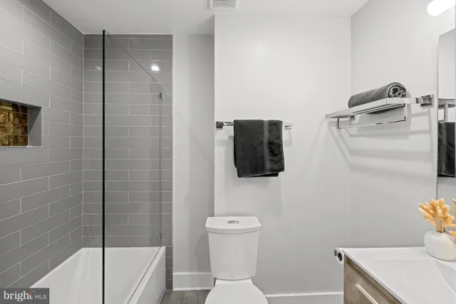 a backyard of a house with barbeque oven and outdoor seating