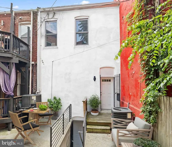 a building exterior with the table and chairs