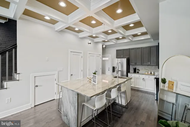 a kitchen with sink a center island and stainless steel appliances
