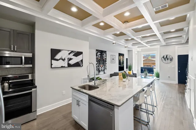 a kitchen with stainless steel appliances granite countertop a stove and a refrigerator