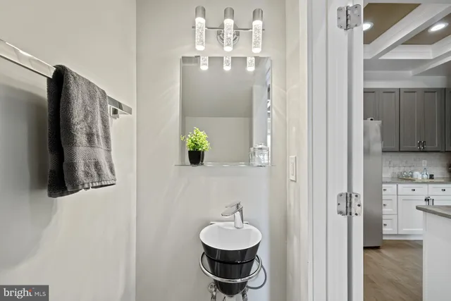 a kitchen with granite countertop a table chairs stove and microwave