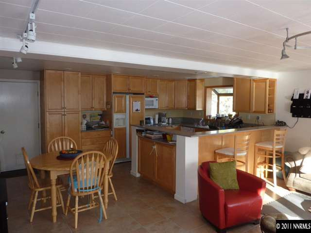 2340 Armstrong Lane Reno, NV 89509 - Photo 3 of 7 a dining table with chairs and kitchen view