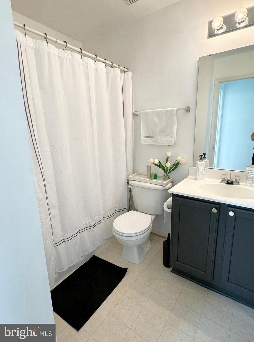 14660 Red House Road Gainesville, VA 20155 - Photo 15 of 20 a bathroom with a sink a toilet a mirror and shower