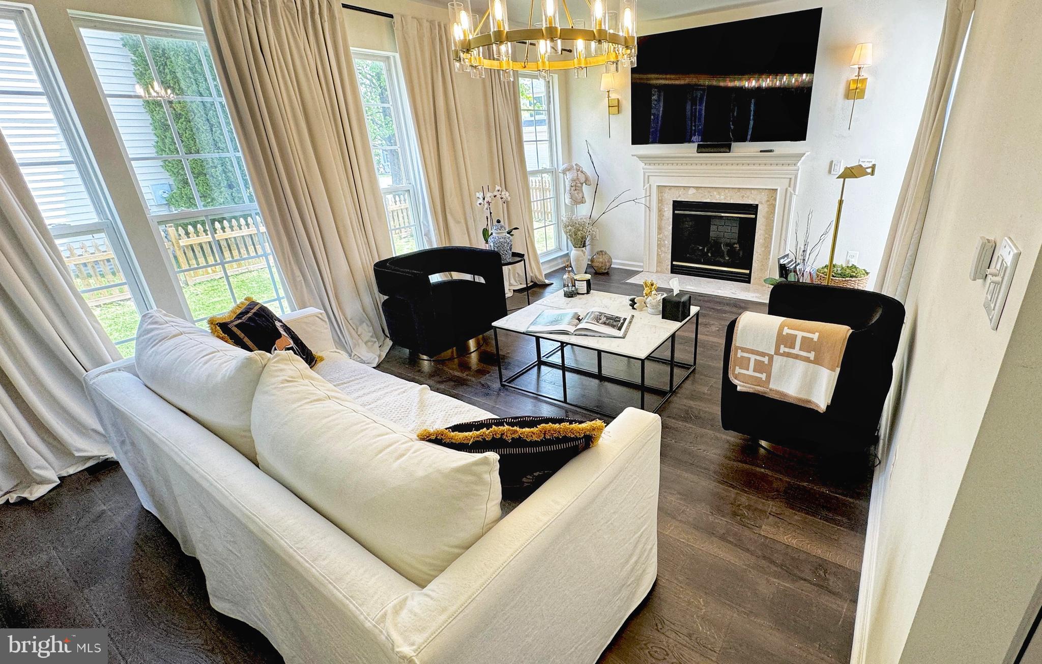 14660 Red House Road Gainesville, VA 20155 - Photo 2 of 20 a living room with furniture a fireplace and a flat screen tv