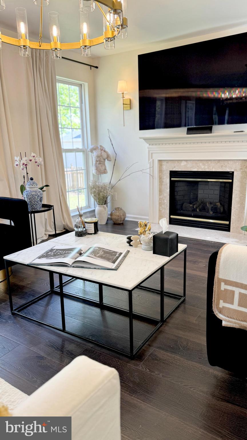 14660 Red House Road Gainesville, VA 20155 - Photo 4 of 20 a living room with a couch a flat screen tv and a fireplace
