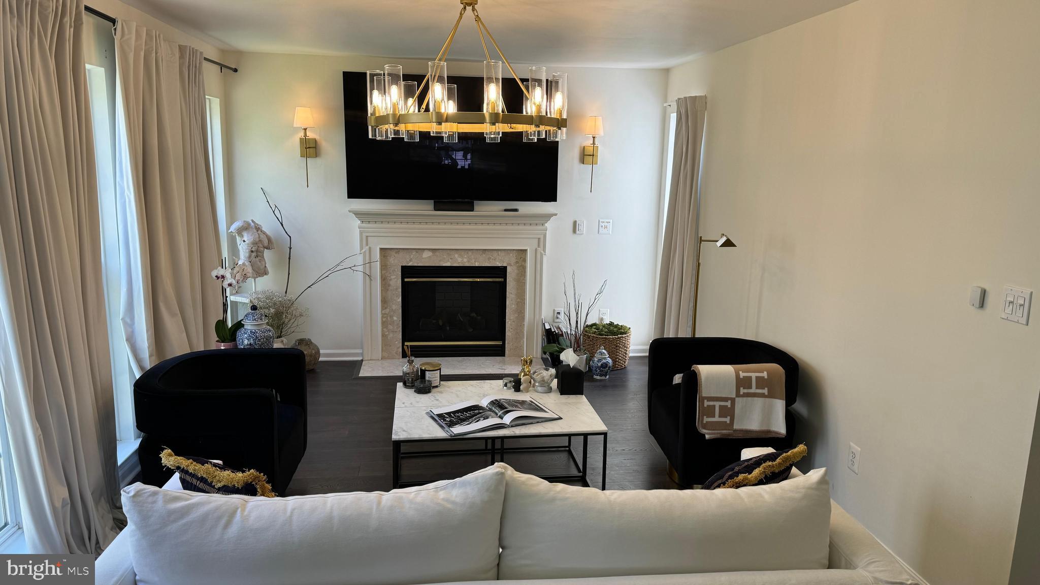 14660 Red House Road Gainesville, VA 20155 - Photo 5 of 20 a living room with furniture a flat screen tv and a fireplace