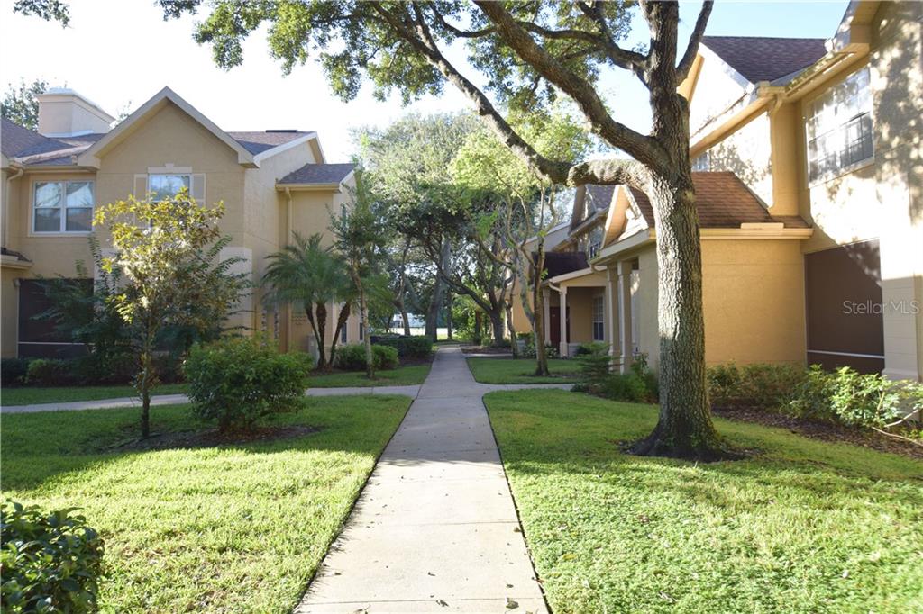 877 Grand Regency Pointe, Unit 104 Altamonte Springs, FL 32714 - Photo 1 of 1 a front view of a house with garden