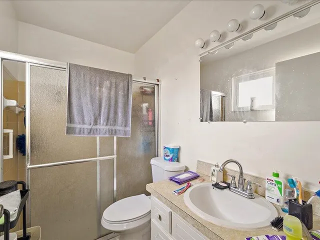 a bathroom with a sink toilet and shower