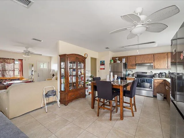 a view of a dining room with furniture and chandelier