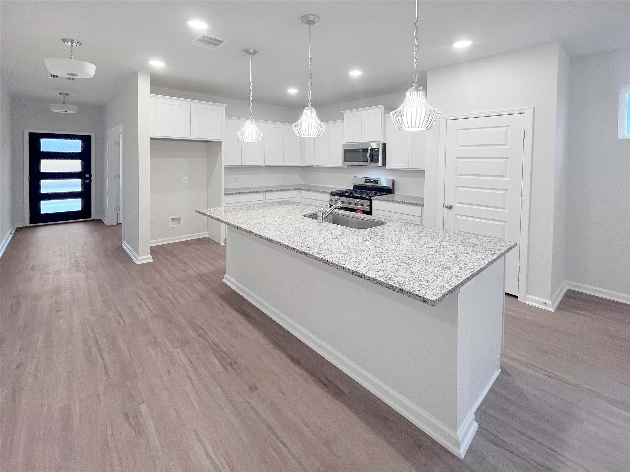 9706 Enclave Ridge Road Willis, TX 77318 - Photo 7 of 19 an open kitchen with a sink dishwasher refrigerator and oven