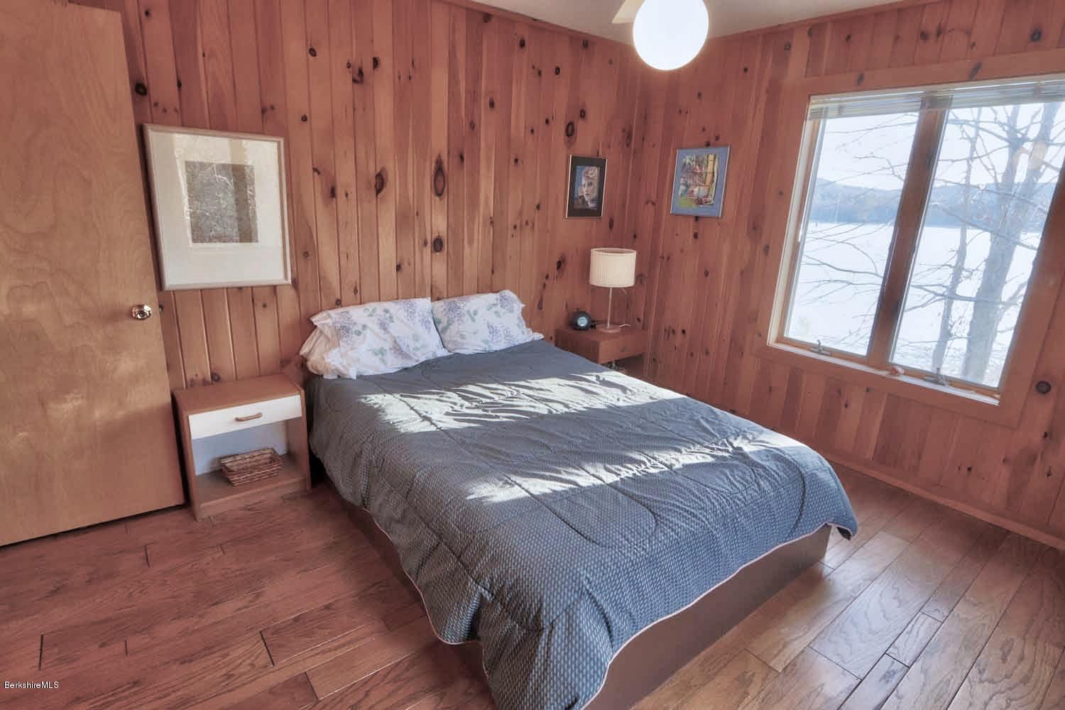 153 Hupi Road Monterey, MA 01245 - Photo 22 of 23 a bed sitting in a bedroom next to a window