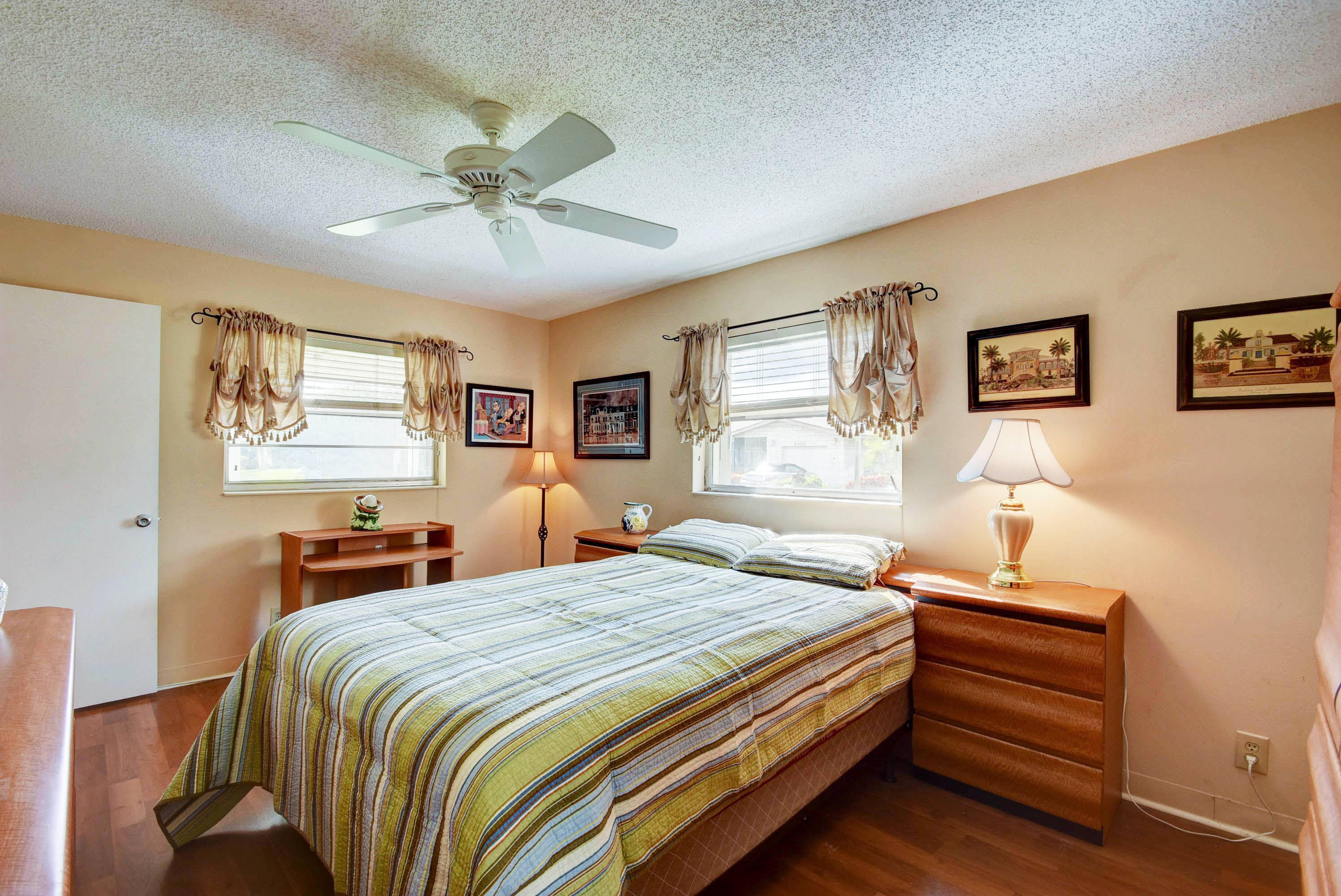 6295 Dusenburg Road Delray Beach, FL 33484 - Photo 27 of 34 a bedroom with a bed and a chandelier