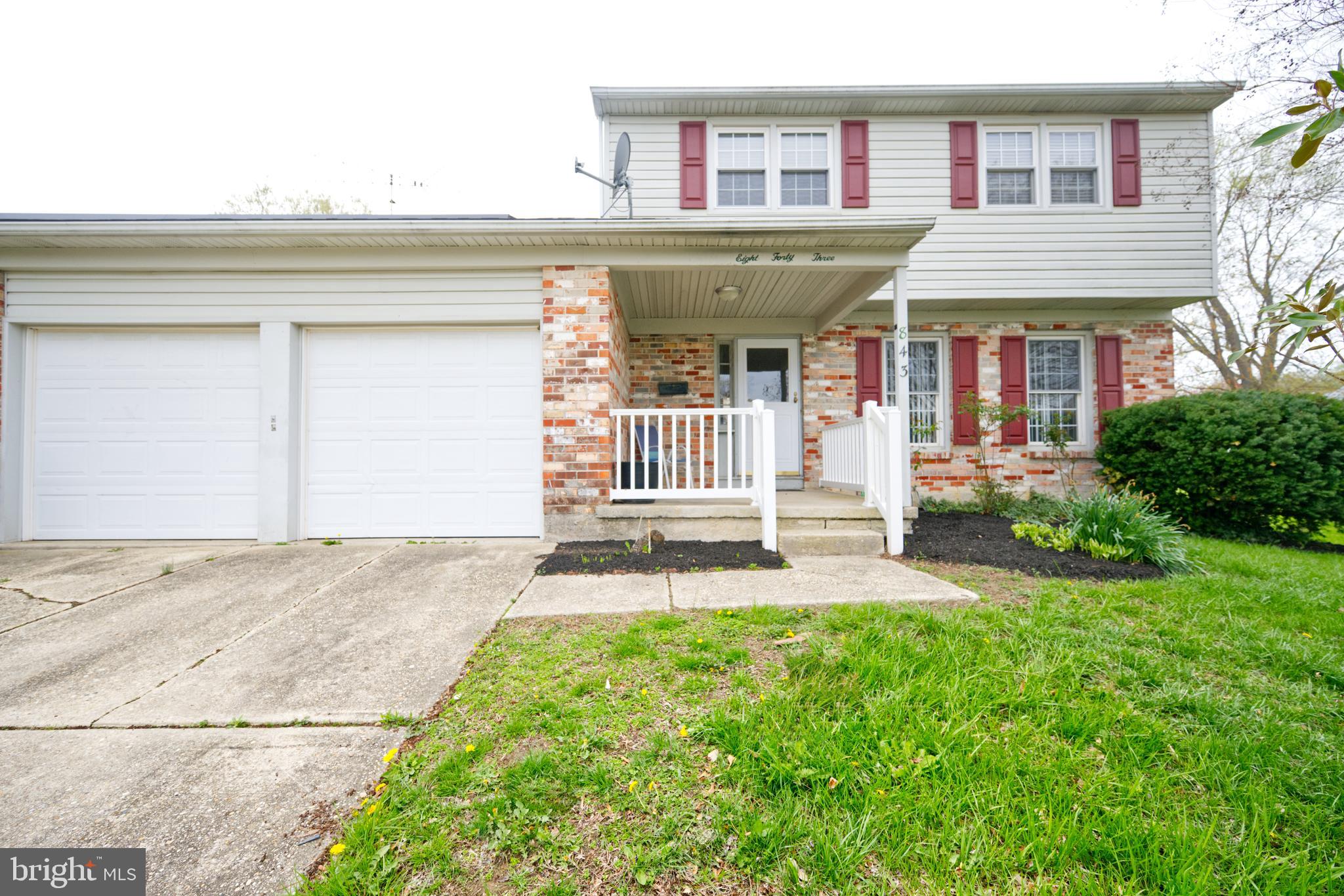 843 Townsend Boulevard Dover, DE 19901 - Photo 3 of 35 a front view of a house with a garden and plants