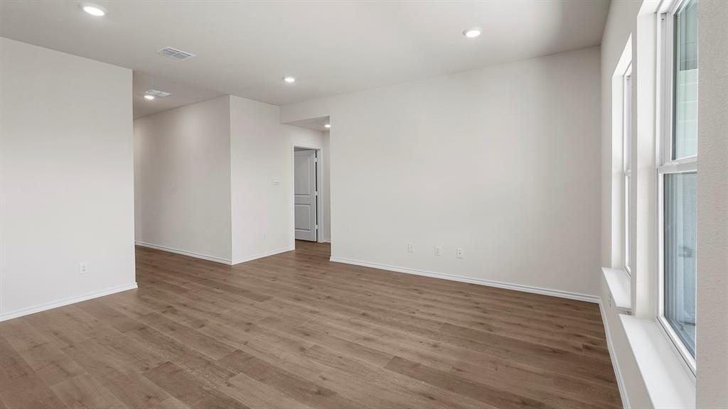 1675 Mantle Road Crandall, TX 75114 - Photo 11 of 27 Spacious interior featuring wood-finish flooring, ample natural light from multiple windows, recessed ceiling lighting, and crisp white walls