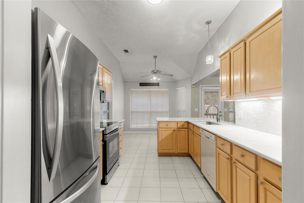 2917 Harlow Road Commerce, TX 75428 - Photo 11 of 40 a large kitchen with stainless steel appliances granite countertop a refrigerator and a sink