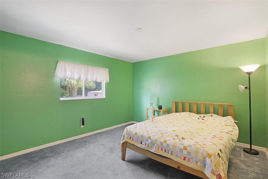 18582 Violet Road Fort Myers, FL 33967 - Photo 14 of 22 a bedroom with a bed and a window
