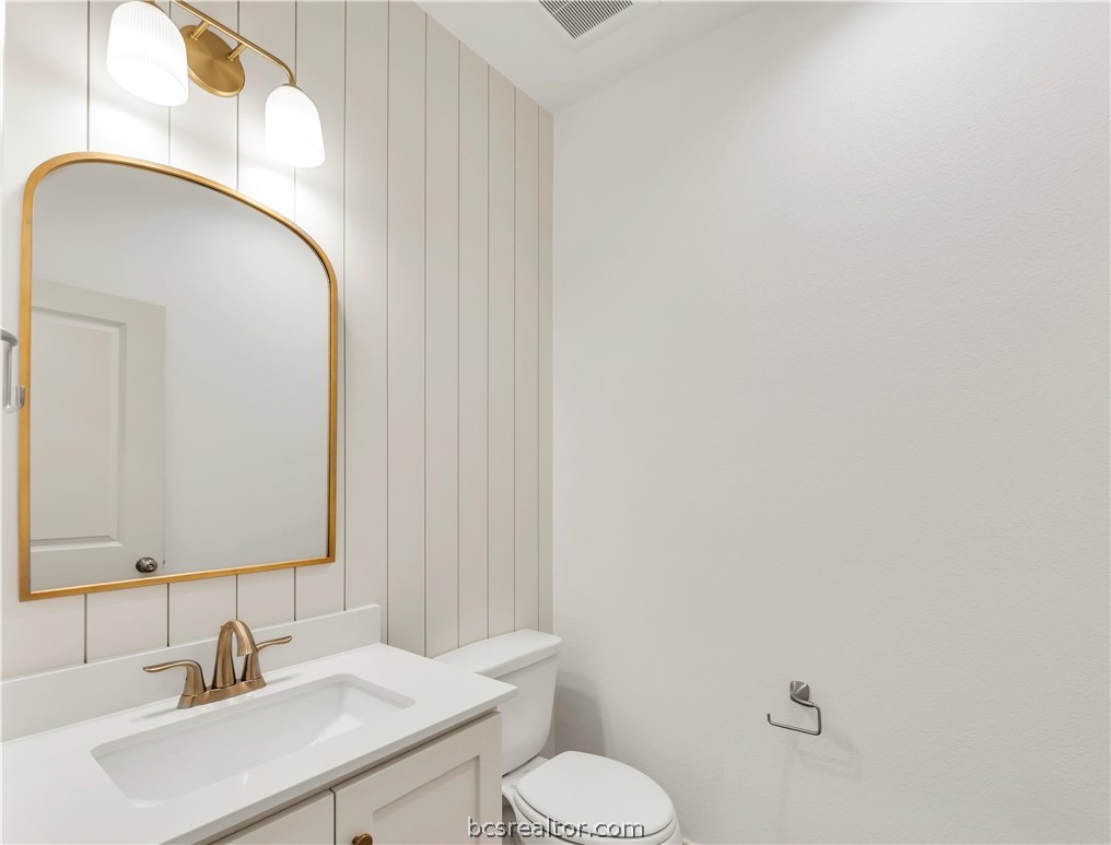 5084 Acadia Loop Bryan, TX 77802 - Photo 17 of 33 a bathroom with a toilet sink and mirror