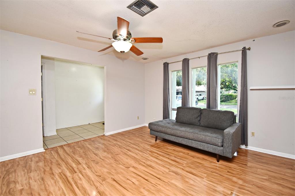 5133 Brenda Drive Orlando, FL 32812 - Photo 11 of 51 a living room with furniture and a large window