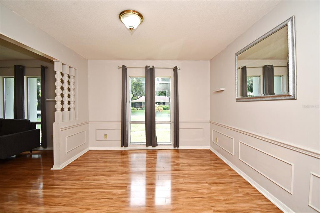 5133 Brenda Drive Orlando, FL 32812 - Photo 13 of 51 a view of an empty room with wooden floor and a window