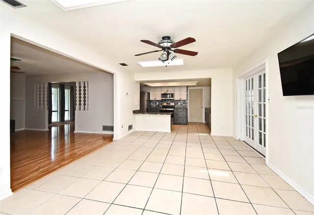 a view of a kitchen with kitchen island granite countertop a refrigerator and a sink