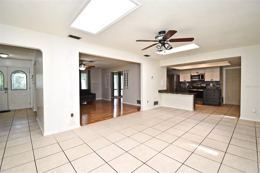 5133 Brenda Drive Orlando, FL 32812 - Photo 18 of 51 a view of a kitchen with kitchen island granite countertop a refrigerator and a sink