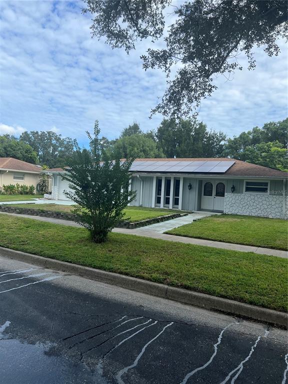 5133 Brenda Drive Orlando, FL 32812 - Photo 2 of 51 a front view of a house with a yard