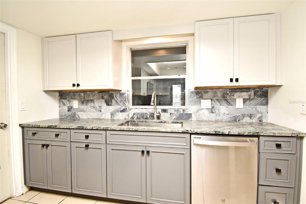 5133 Brenda Drive Orlando, FL 32812 - Photo 24 of 51 a kitchen with granite countertop a sink and cabinets