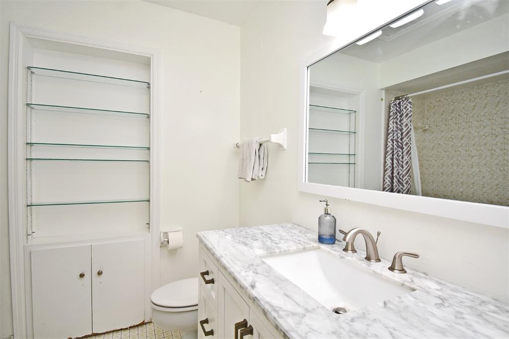 5133 Brenda Drive Orlando, FL 32812 - Photo 26 of 51 a bathroom with a sink a toilet and vanity