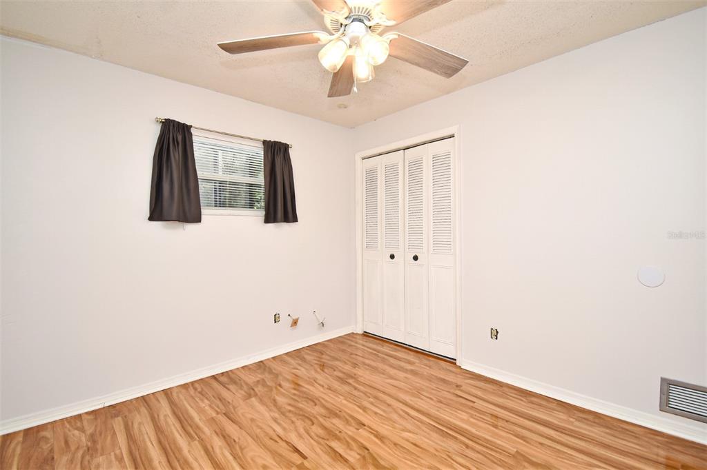 5133 Brenda Drive Orlando, FL 32812 - Photo 29 of 51 a view of a bedroom with wooden floor and a ceiling fan