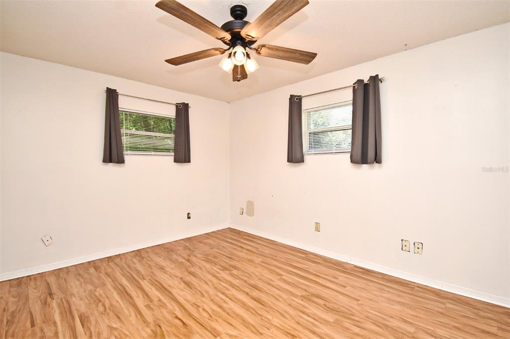 5133 Brenda Drive Orlando, FL 32812 - Photo 31 of 51 a view of a bedroom with wooden floor and a ceiling fan