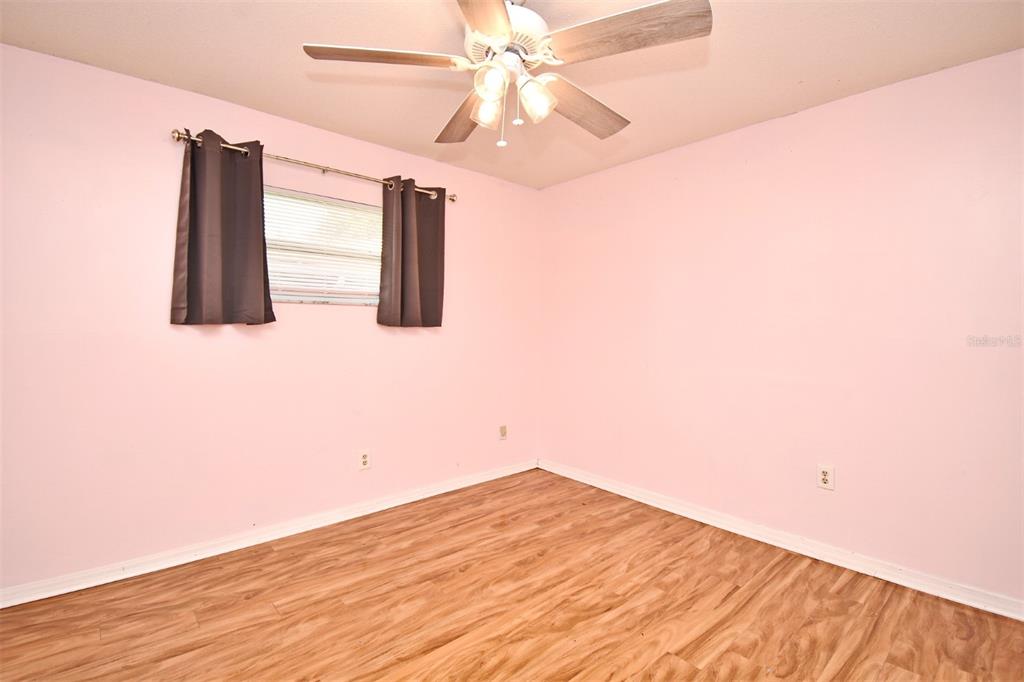 5133 Brenda Drive Orlando, FL 32812 - Photo 34 of 51 a view of a room with wooden floor and ceiling fan