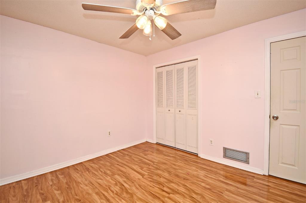 5133 Brenda Drive Orlando, FL 32812 - Photo 35 of 51 a view of a room with wooden floor and ceiling fan
