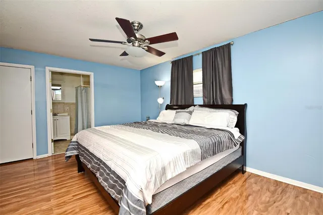 a bedroom with a large bed and a chandelier