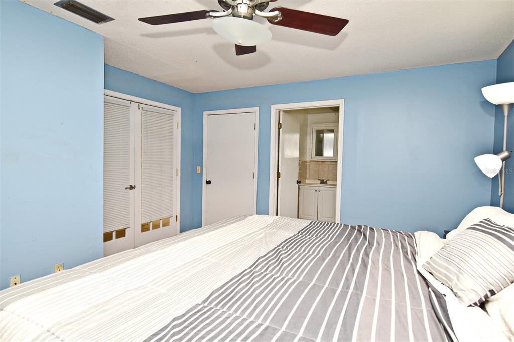 5133 Brenda Drive Orlando, FL 32812 - Photo 39 of 51 a bedroom with a large bed and a chandelier