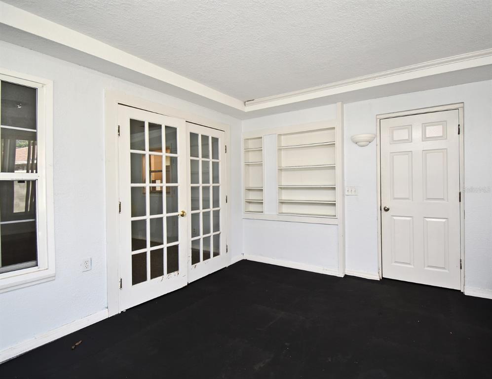 5133 Brenda Drive Orlando, FL 32812 - Photo 43 of 51 an empty room with wooden floor and windows