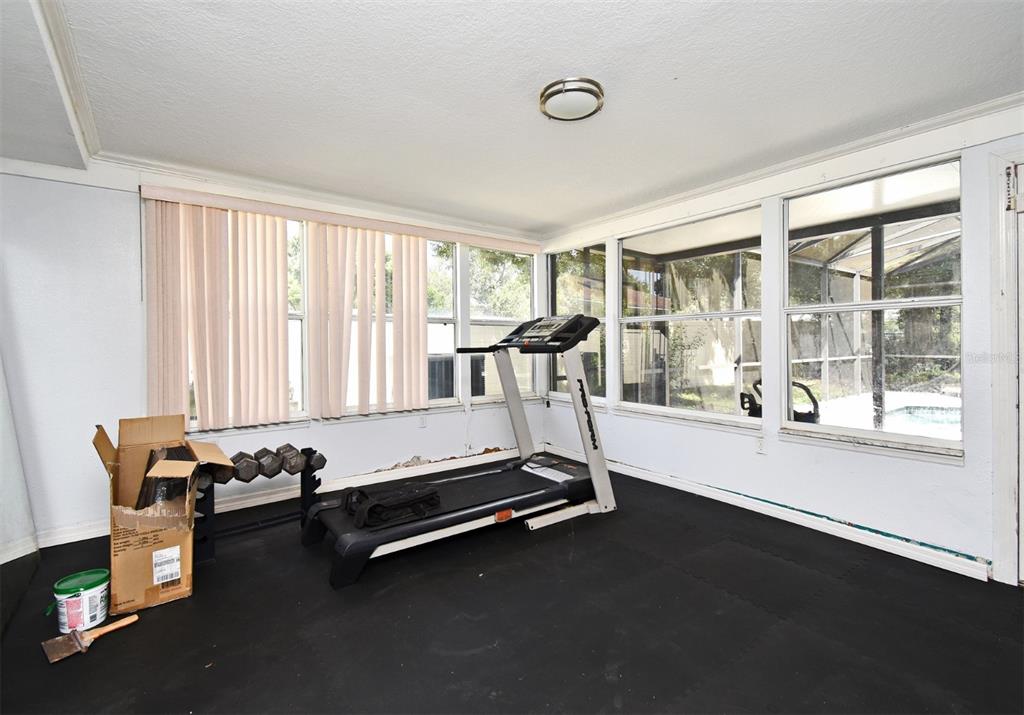 5133 Brenda Drive Orlando, FL 32812 - Photo 51 of 51 a room with gym equipment and windows