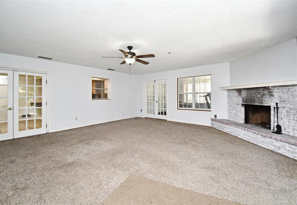 5133 Brenda Drive Orlando, FL 32812 - Photo 6 of 51 a view of an empty room with a fireplace and a window