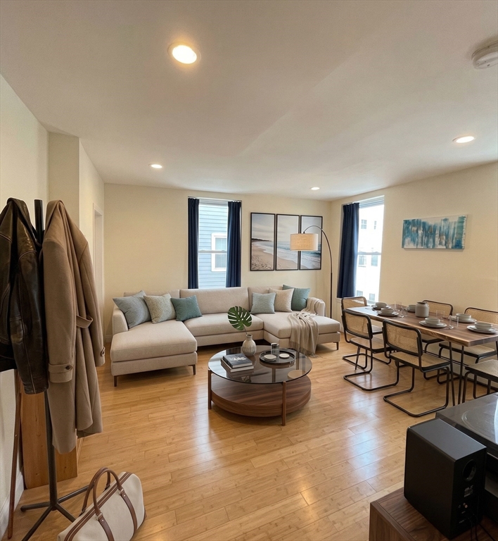 a living room with furniture window and wooden floor