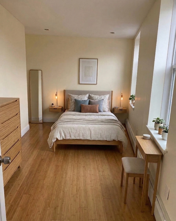 212 Maverick Street, Unit 3 Boston, MA 02128 - Photo 3 of 9 a bedroom with a bed and a table