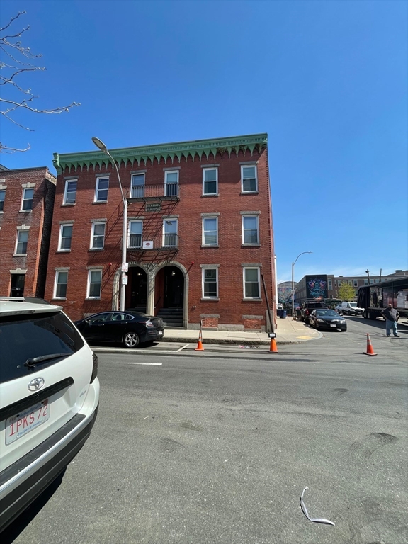 212 Maverick Street, Unit 3 Boston, MA 02128 - Photo 8 of 9 a front view of a building with parking