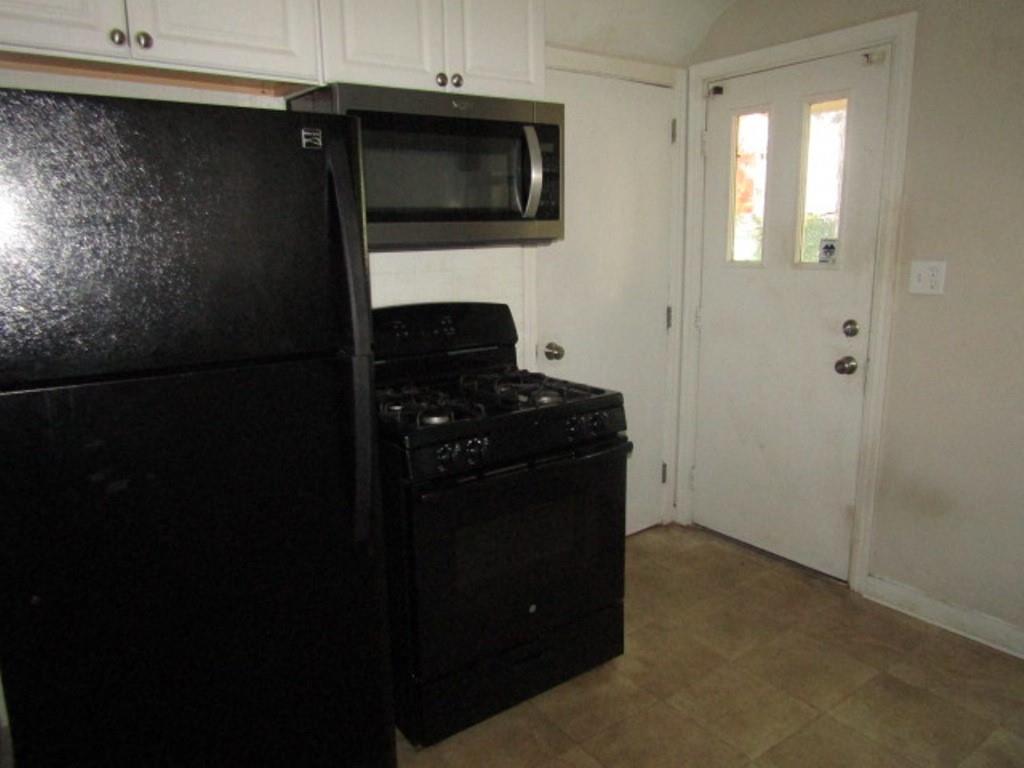 8601 Westwood Road Pittsburgh, PA 15235 - Photo 16 of 28 a kitchen with a refrigerator and a stove top oven