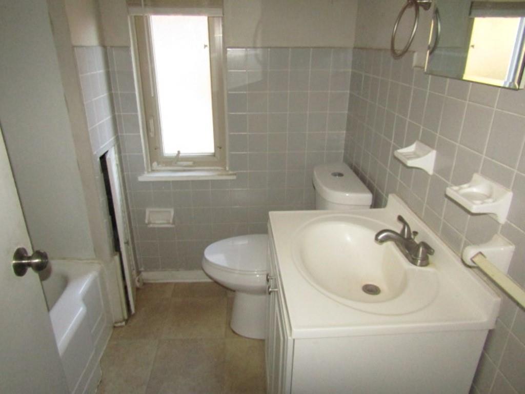 8601 Westwood Road Pittsburgh, PA 15235 - Photo 18 of 28 a bathroom with a sink a toilet and a mirror