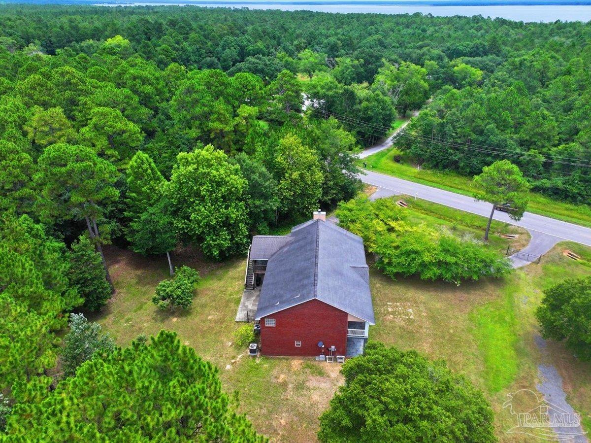 2099 Garcon Point Road Milton, FL 32583 - Photo 18 of 65 an aerial view of a house with a yard and outdoor seating