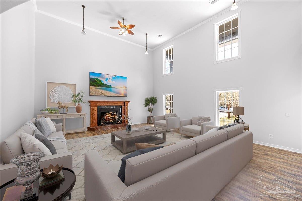 2099 Garcon Point Road Milton, FL 32583 - Photo 27 of 65 a living room with furniture a fireplace and a flat screen tv