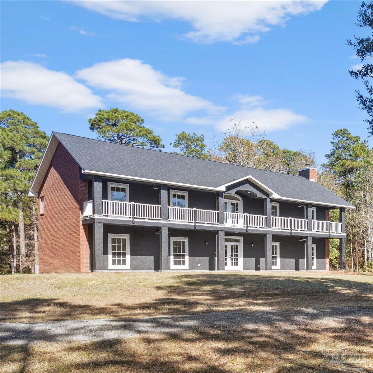2099 Garcon Point Road Milton, FL 32583 - Photo 3 of 65 front view of a building with a garden