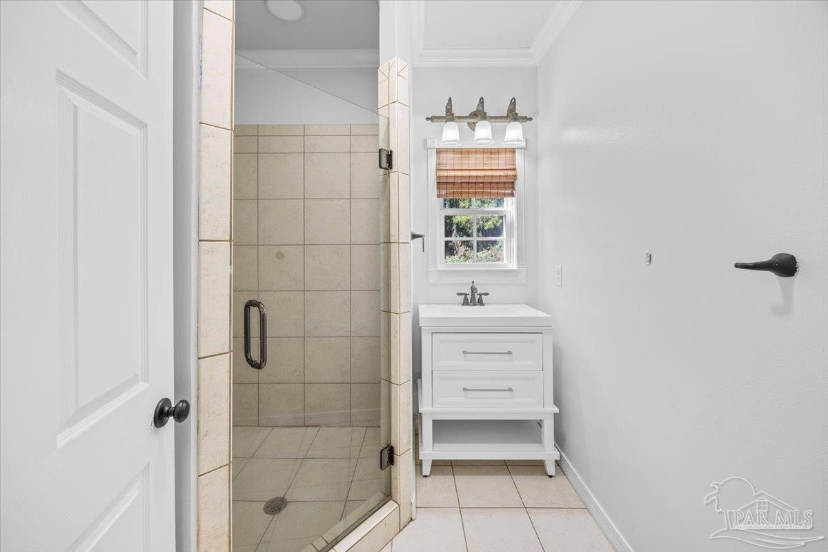 2099 Garcon Point Road Milton, FL 32583 - Photo 35 of 65 a bathroom with a sink a toilet and shower